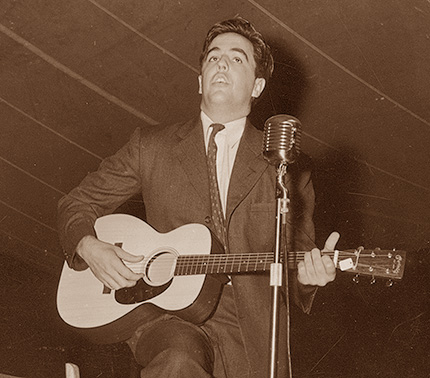 Alan Lomax playing guitar in NC circa 1940